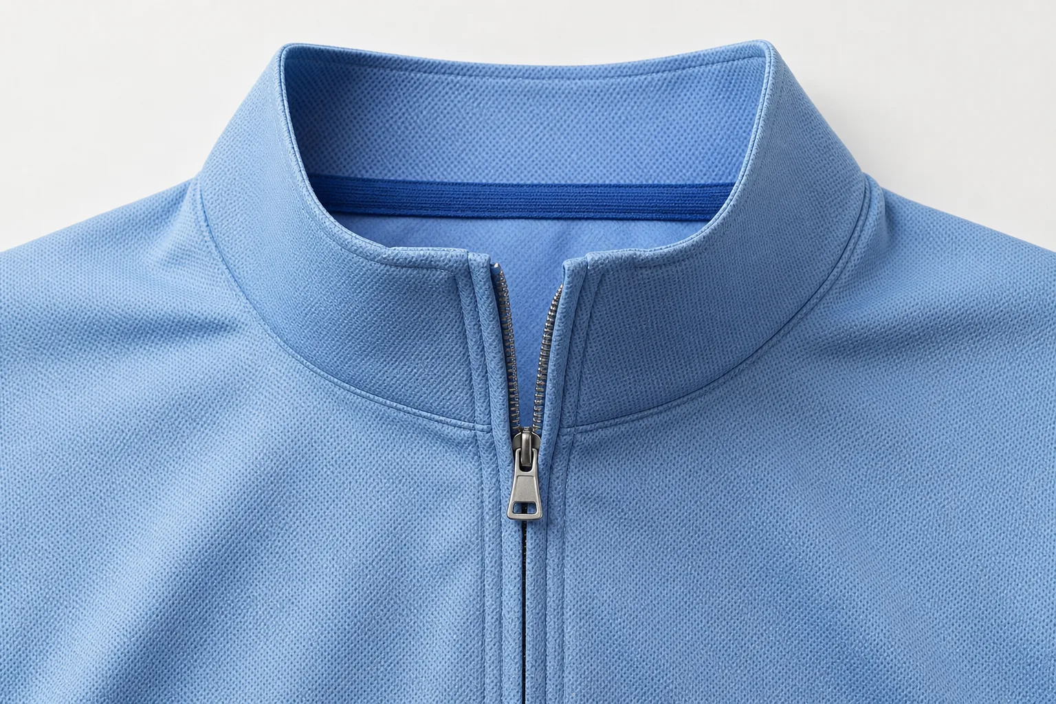 Detail view of quarter-zip collar shape and front zipper construction